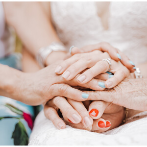 Hände mehrerer Generationen übereinander